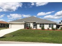 One-story home with gray roof and landscaping at 26332 Barranquilla Ave, Punta Gorda, FL 33983