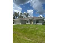 Charming one-story home with well-maintained lawn and attached two car garage at 5546 Wagon Wheel Dr, North Port, FL 34291