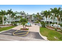 Condo building with gated entrance and lush landscaping at 5127 Melbourne St # F-204, Port Charlotte, FL 33980