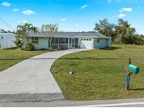 Single Gathering home with carport and yard at 3341 Rock Creek Dr, Port Charlotte, FL 33948