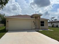 Well-maintained single-Gathering home with a two car garage, and a well manicured lawn at 22235 Albany Ave, Port Charlotte, FL 33952