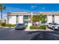 Two-story condo building with parking and landscaping at 1439 Mediterranean Dr # C, Punta Gorda, FL 33950