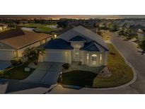 Night view of a single-story house with a well-maintained lawn at 1712 Lastingham Ln, Port Charlotte, FL 33980