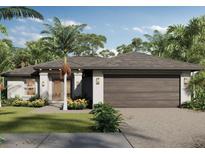 Charming single-story home featuring a two-car garage, lush landscaping, and a welcoming front entrance at 23359 Mcmanaway Ave, Port Charlotte, FL 33980