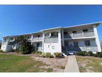 Building exterior of Fiddlers Green Condominiums, featuring a clean, modern design and landscaping at 6800 Placida Rd # 144, Englewood, FL 34224