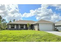 One-story home with gray siding and a two-car garage at 321 Gaynor Ln, Port Charlotte, FL 33953