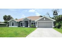 New construction home with gray exterior and two-car garage at 174 Aurora St, Port Charlotte, FL 33948