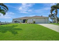 Single story home with attached garage and manicured lawn at 24303 Contra Costa Ln, Punta Gorda, FL 33955