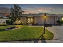 Charming single-story house with well-maintained lawn at 24275 Buckingham Way, Punta Gorda, FL 33980