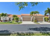Two-story stucco home with a two-car garage and lush landscaping at 5081 San Rocco Ct, Punta Gorda, FL 33950