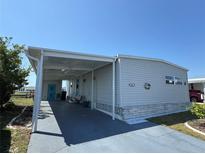 Well-maintained single-story home featuring a covered carport and neat landscaping at 542 Tampico Dr, North Port, FL 34287