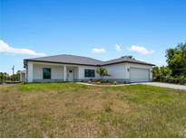 Single-story home with attached garage and landscaping at 13409 Warba Ave, Port Charlotte, FL 33981