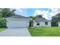One-story home with attached garage and landscaped yard at 4051 Dotham St, Port Charlotte, FL 33948