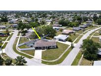 Aerial view of single-Gathering home with pool and fenced backyard, located in a residential neighborhood at 22260 Aburto Ln, Port Charlotte, FL 33952