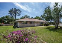 Brick ranch house with well-maintained lawn at 20567 Midway Blvd, Port Charlotte, FL 33952