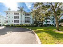 3-story building with balconies and lush landscaping at 5115 Melbourne St # A303, Port Charlotte, FL 33980