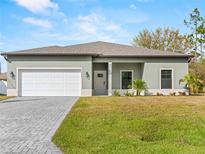 New construction home with a two-car garage and front yard at 2795 Calabash Ln, North Port, FL 34286