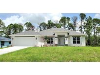Newly built home with grey roof, white exterior, and landscaping at 2536 Jacobs St, Port Charlotte, FL 33953