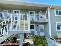 Two-story building exterior, showing building entrance and stairs at 3310 Loveland Blvd # 606, Punta Gorda, FL 33980