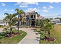 Stunning two-story house with palm trees and circular driveway at 18189 Ohara Dr, Port Charlotte, FL 33948