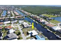 Aerial view showcasing a waterfront lot with canal access in a residential community at 2817 Coral Way, Punta Gorda, FL 33950