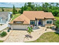 Single-Gathering home with a large driveway and landscaped yard at 16681 Acapulco Rd, Punta Gorda, FL 33955