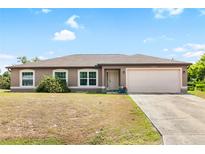 One-story home with brown stucco siding and attached garage at 4530 Irdell Ter, North Port, FL 34288