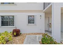 Exterior view of condo building, showing unit entrance with landscaping at 26485 Rampart Blvd # D3, Punta Gorda, FL 33983