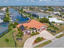 Waterfront home with canal access and lush landscaping at 1081 Coronado Dr, Punta Gorda, FL 33950