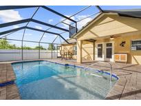 Inviting pool area with screened enclosure and patio furniture at 7106 Parnell Ter, Englewood, FL 34224