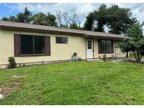 Ranch-style home with landscaped lawn at 1160 Belkton Ave, Port Charlotte, FL 33948