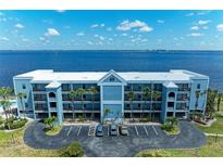 Blue waterfront building with parking and water access at 1750 Jamaica Way # 113, Punta Gorda, FL 33950