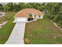 New construction home with driveway and lawn at 820 Bowman Ter, Port Charlotte, FL 33953