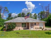 Charming light pink house with American flag at 7263 Sablon Rd, North Port, FL 34291