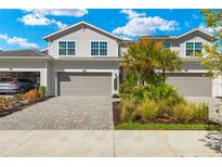 Two-story townhome with attached garage and landscaped front yard at 15999 Grassland Ln # 3221, Punta Gorda, FL 33982
