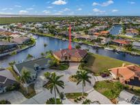 Bird's eye view of canal-front property with lush landscaping at 3629 Bonaire Ct, Punta Gorda, FL 33950