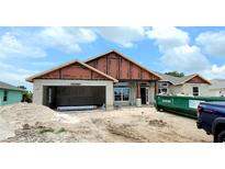 New house under construction with a two-car garage at 9 Broadmoor Ln, Rotonda West, FL 33947