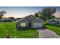 Single-story house with a two-car garage and landscaped yard at 27441 Natal Dr, Punta Gorda, FL 33983