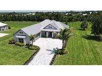 Single-Gathering home with metal roof and paved driveway at 28976 Gin Ln, Punta Gorda, FL 33982