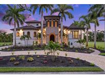 Mediterranean style home with landscaping and a paved driveway at 21321 Harborside Blvd, Port Charlotte, FL 33952