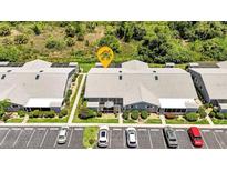 Aerial view of a condo building with parking and surrounding landscape at 3300 Loveland Blvd # 1301, Punta Gorda, FL 33980