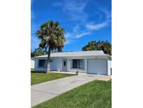 Cute one-story home with palm tree and driveway at 1286 Hillcrest Nw Ave, Port Charlotte, FL 33948
