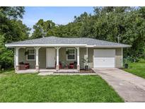 Charming one-story house with covered porch and attached garage at 265 Tipton St, Port Charlotte, FL 33954