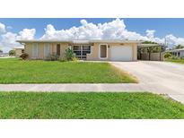 Tan single story home with attached garage and carport at 101 Cousley Se Dr, Port Charlotte, FL 33952