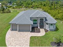 Aerial view of a single-Gathering home with three-car garage at 14041 Clarissa Ln, Port Charlotte, FL 33981