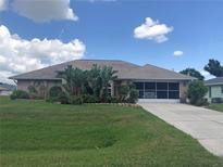 One-story house with a landscaped yard and attached garage at 7100 Mineola Rd, Englewood, FL 34224