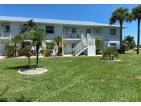 Two-story condo building with lush landscaping at 26470 Rampart Blvd # 123, Punta Gorda, FL 33983