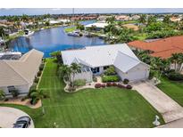 Single-story home with canal views and lush landscaping at 3621 Whippoorwill Blvd, Punta Gorda, FL 33950