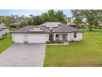 Two-car garage, solar panels, and nicely landscaped yard at 16195 Maya Cir, Punta Gorda, FL 33955