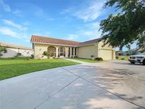 Single-story home with a well-maintained lawn at 695 Coronado Dr, Punta Gorda, FL 33950